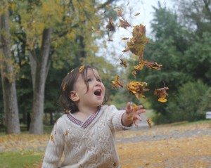 Little Boy Throwing Leaves